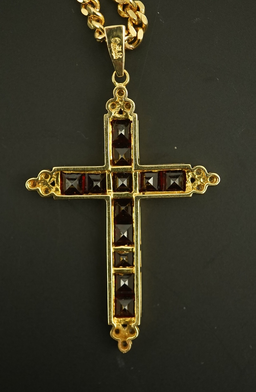 A modern 18ct gold, garnet and diamond chip cluster set cross pendant, 42mm, gross weight 6.5 grams, on a modern 9ct gold curb link chain